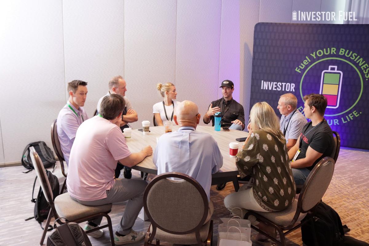 Members working through a hot seat around a table